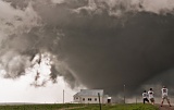 Storm chasers photograph tornado passing behind church - near Howes, South Dakota