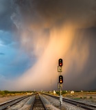 Sunlit rain shaft over railroad tracks - Eloy, Arizona