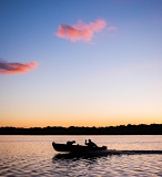 Man and dog in boat at dusk - Horicon Marsh, Wisconsin