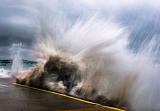 Wave crashing against seawall - Barwon Heads, Victoria, Australia