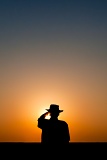 Farmer staring at setting sun - Melrose, New Mexico